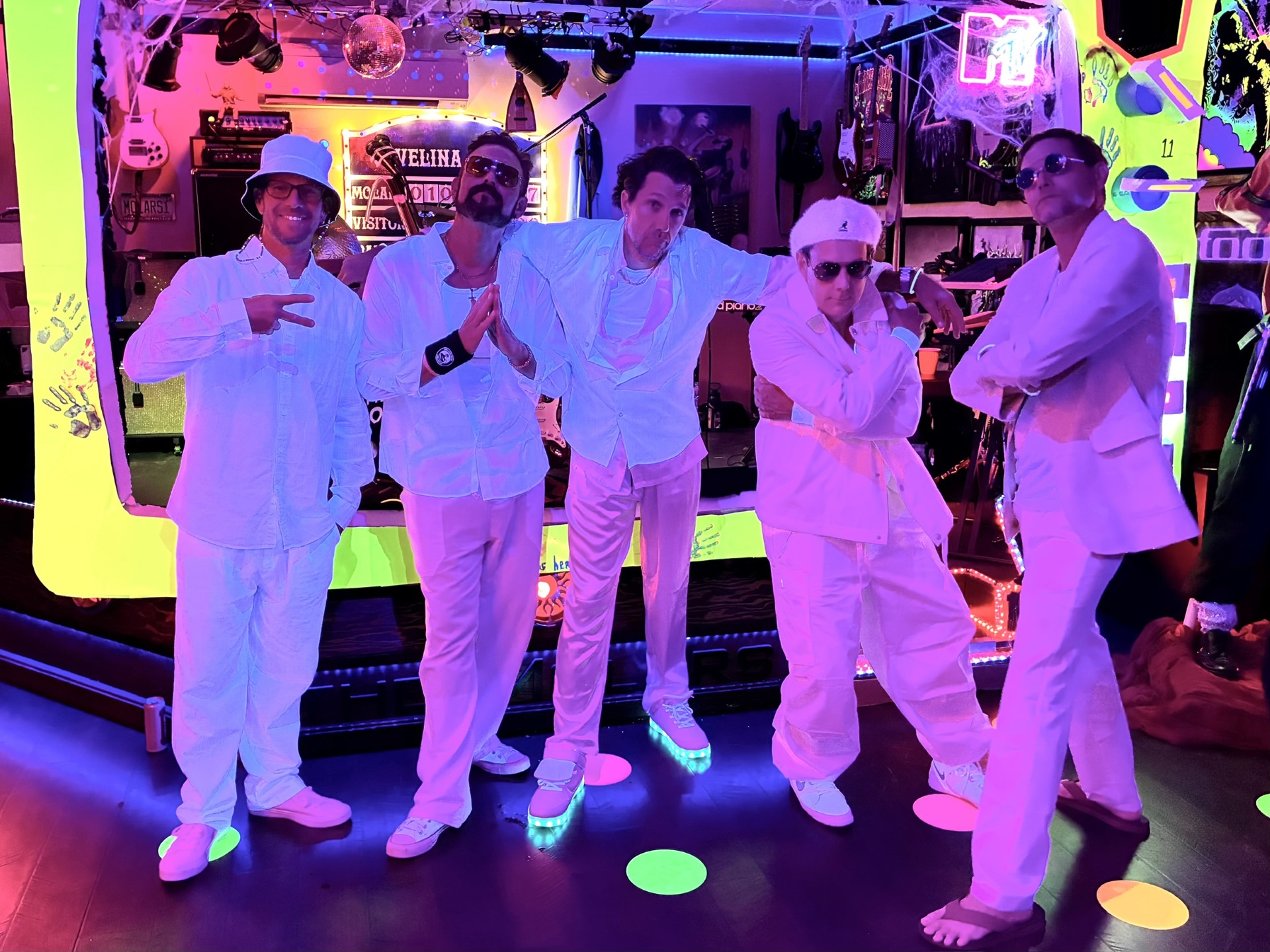 The Molars2 The Molars band posing together in white costumes on their performance stage